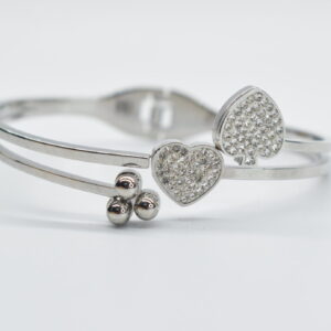 STEEL HANDCUFF IN SILVER COLOUR WITH LITTLE HEARTS AND BALLS.