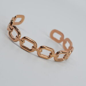 STEEL HANDCUFF IN GOLDEN PINK COLOUR WITH HOOPS.