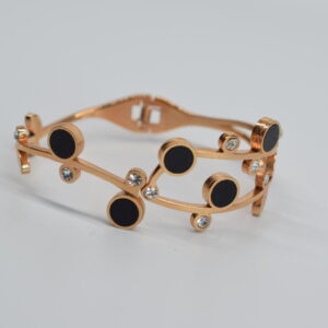 STEEL HANDCUFF IN GOLDEN PINK COLOUR WITH RHINESTONES AND BLACK FEATURES.